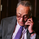 Senate Majority Leader Chuck Schumer takes a phone call.